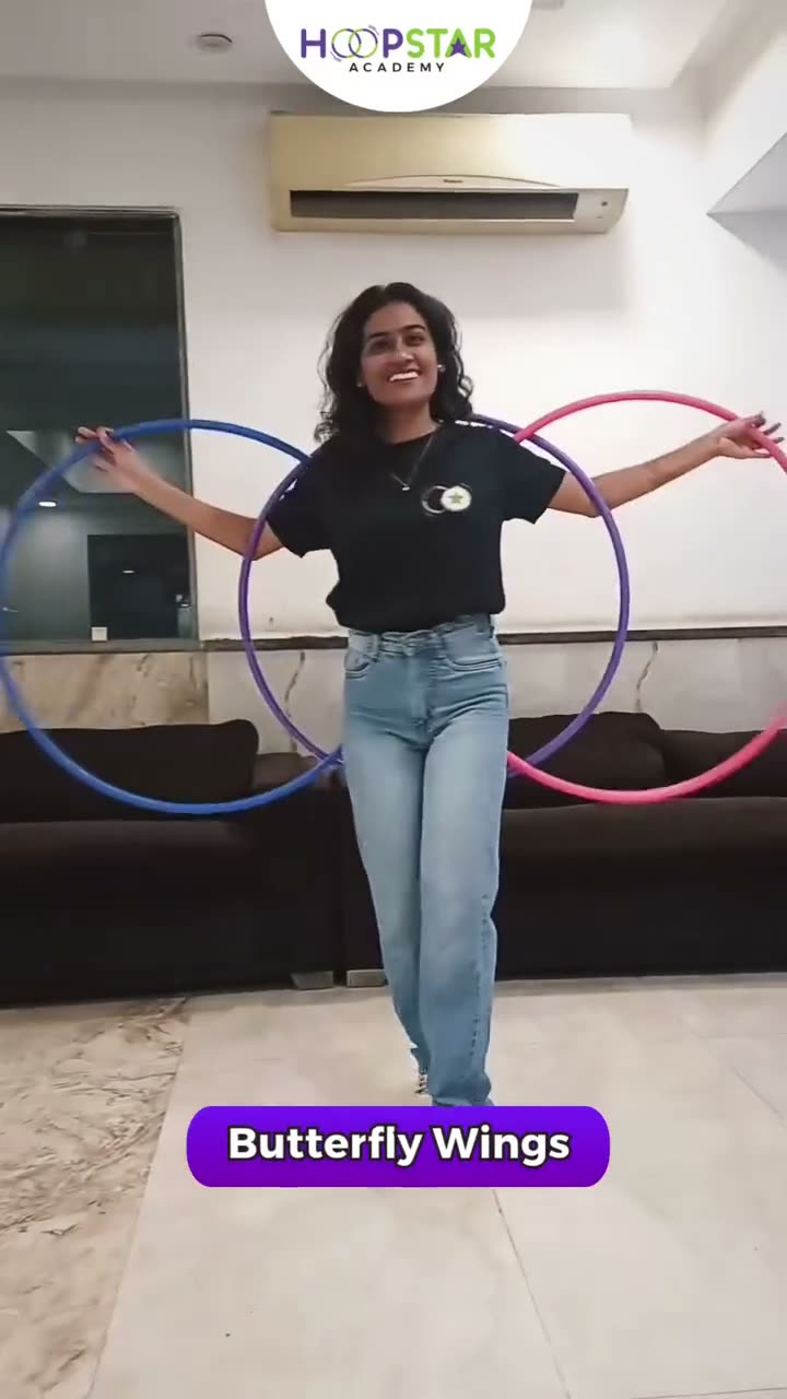 A child demonstrating Butterfly Wings — a Level 3 hula hoop skill