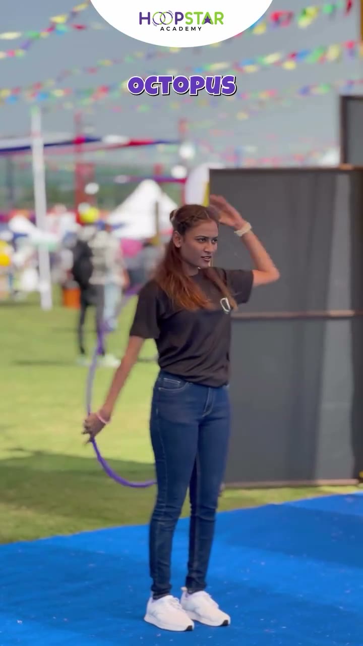 A child demonstrating Elbow Hooping — a Level 1 hula hoop skill