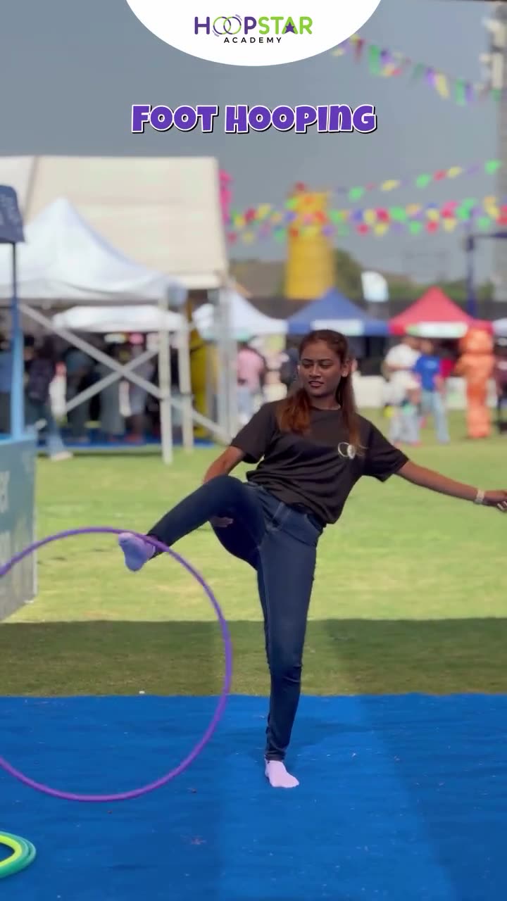 A child demonstrating Foot Hooping — a Level 2 hula hoop skill