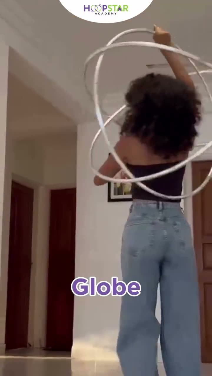 A child demonstrating Globe — a Level 5 hula hoop skill