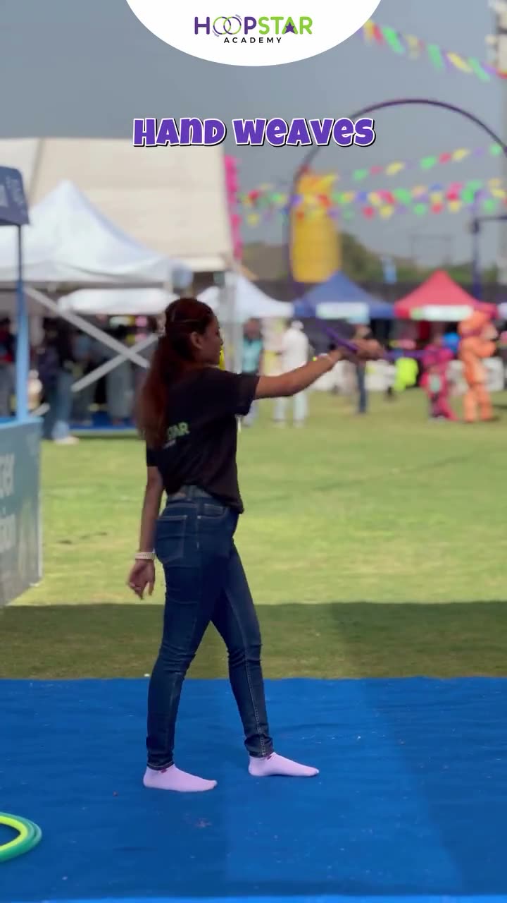 A child demonstrating Hand Weaves — a Level 2 hula hoop skill