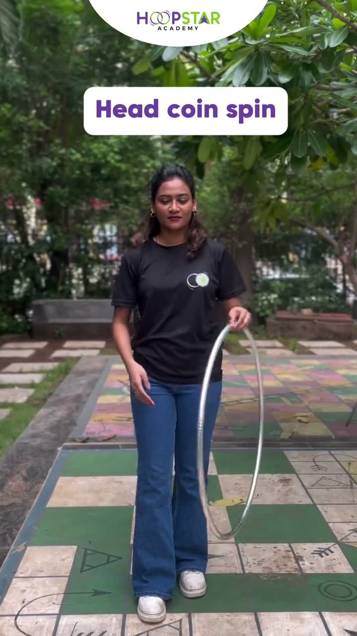 A child demonstrating Head Coin Spin — a Level 6 hula hoop skill