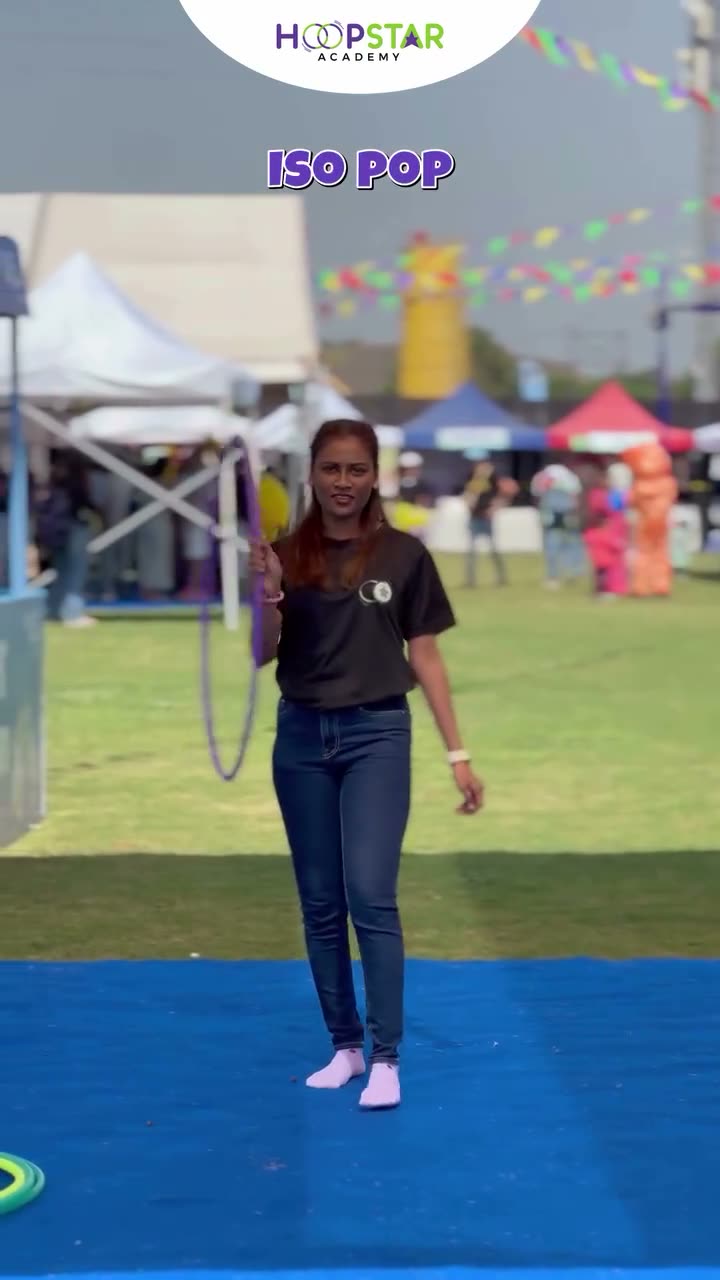 A child demonstrating ISO Pop — a Level 2 hula hoop skill