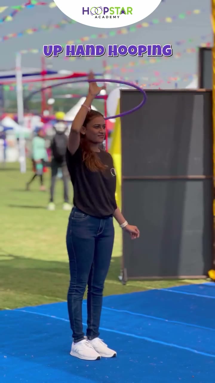 A child demonstrating Leg Hooping — a Level 1 hula hoop skill