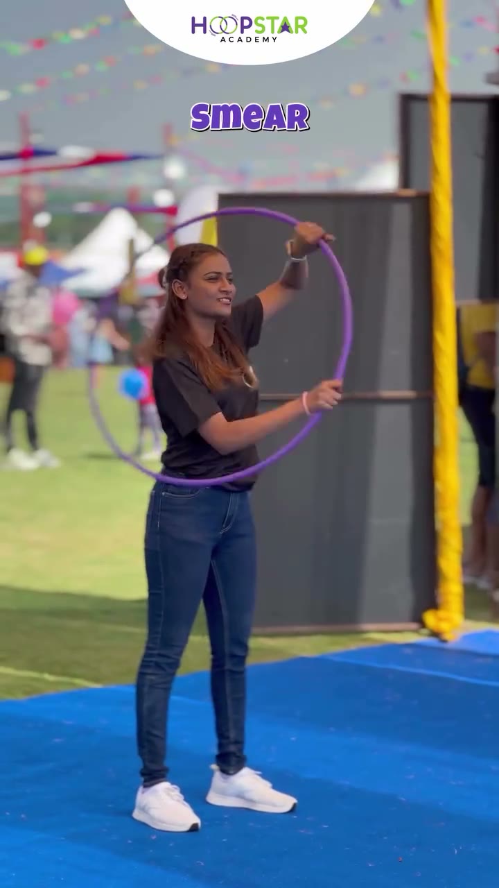 A child demonstrating Neck to Waist — a Level 1 hula hoop skill