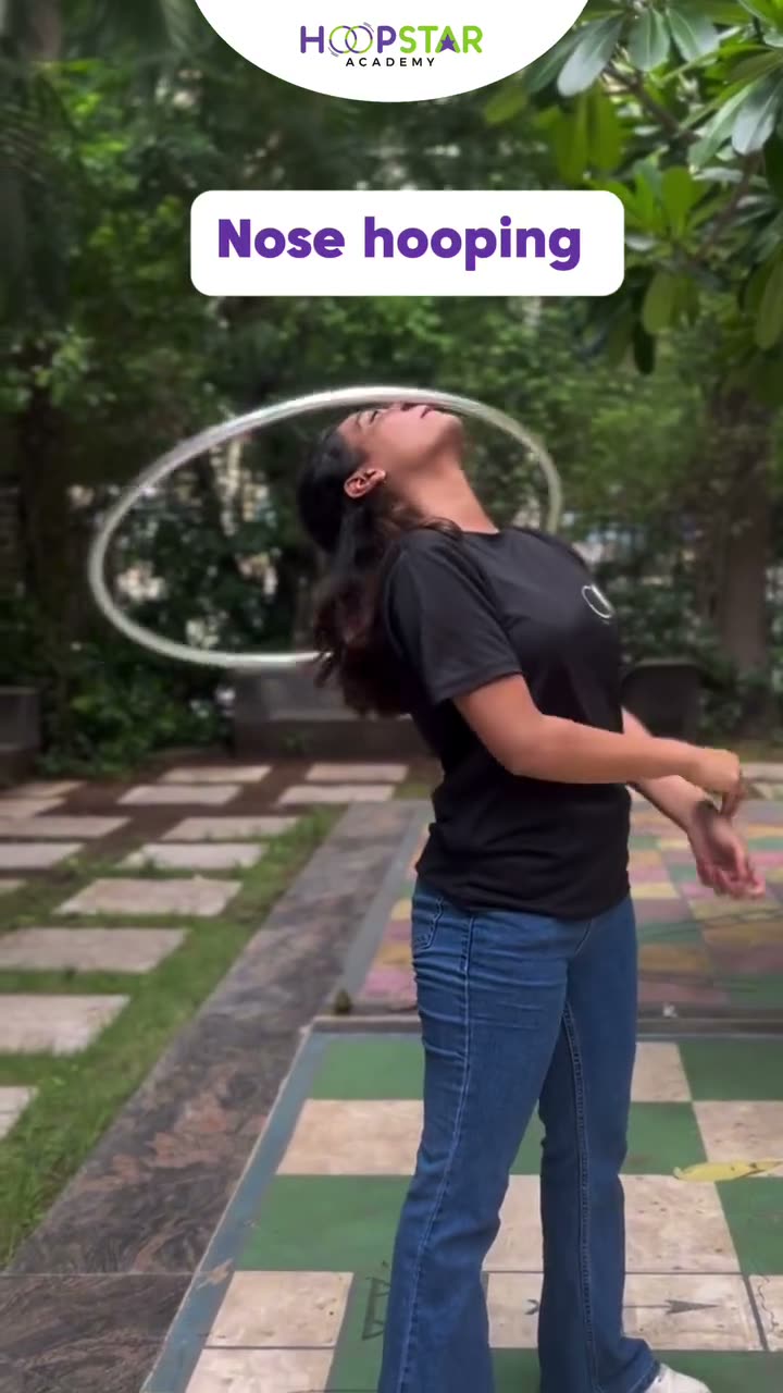 A child demonstrating Nose Hooping — a Level 6 hula hoop skill