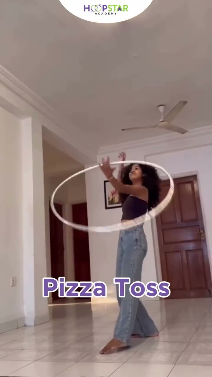 A child demonstrating Pizza Toss — a Level 4 hula hoop skill