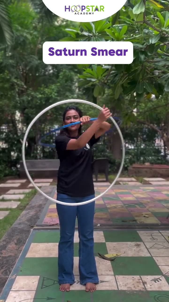 A child demonstrating Saturn Smear — a Level 6 hula hoop skill