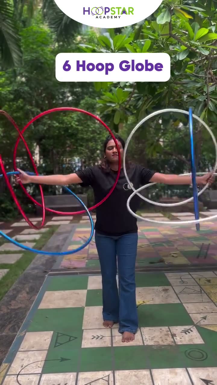 A child demonstrating 6 Hoop Globe — a Level 6 hula hoop skill
