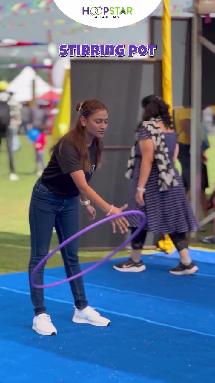A child demonstrating Stirring Pot — a Level 1 hula hoop skill