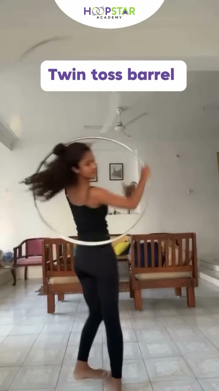 A child demonstrating Twin Toss Barrel — a Level 5 hula hoop skill
