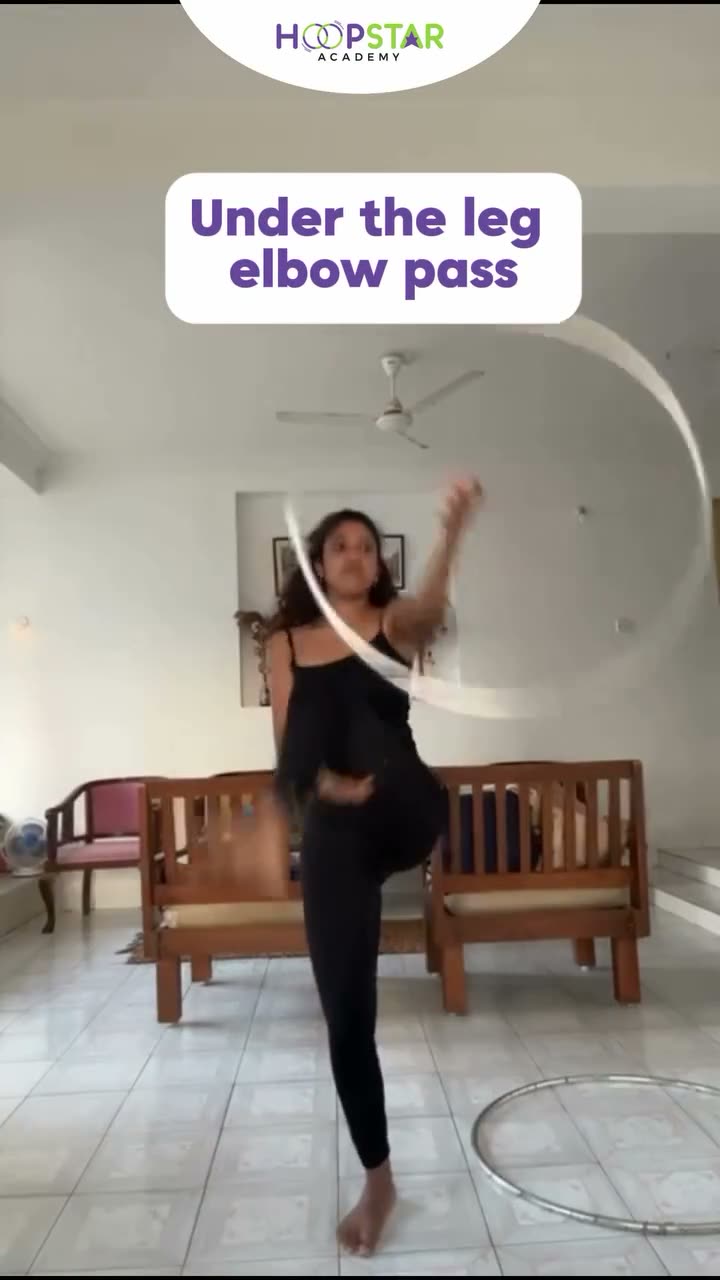 A child demonstrating Under the Leg Elbow Pass — a Level 5 hula hoop skill