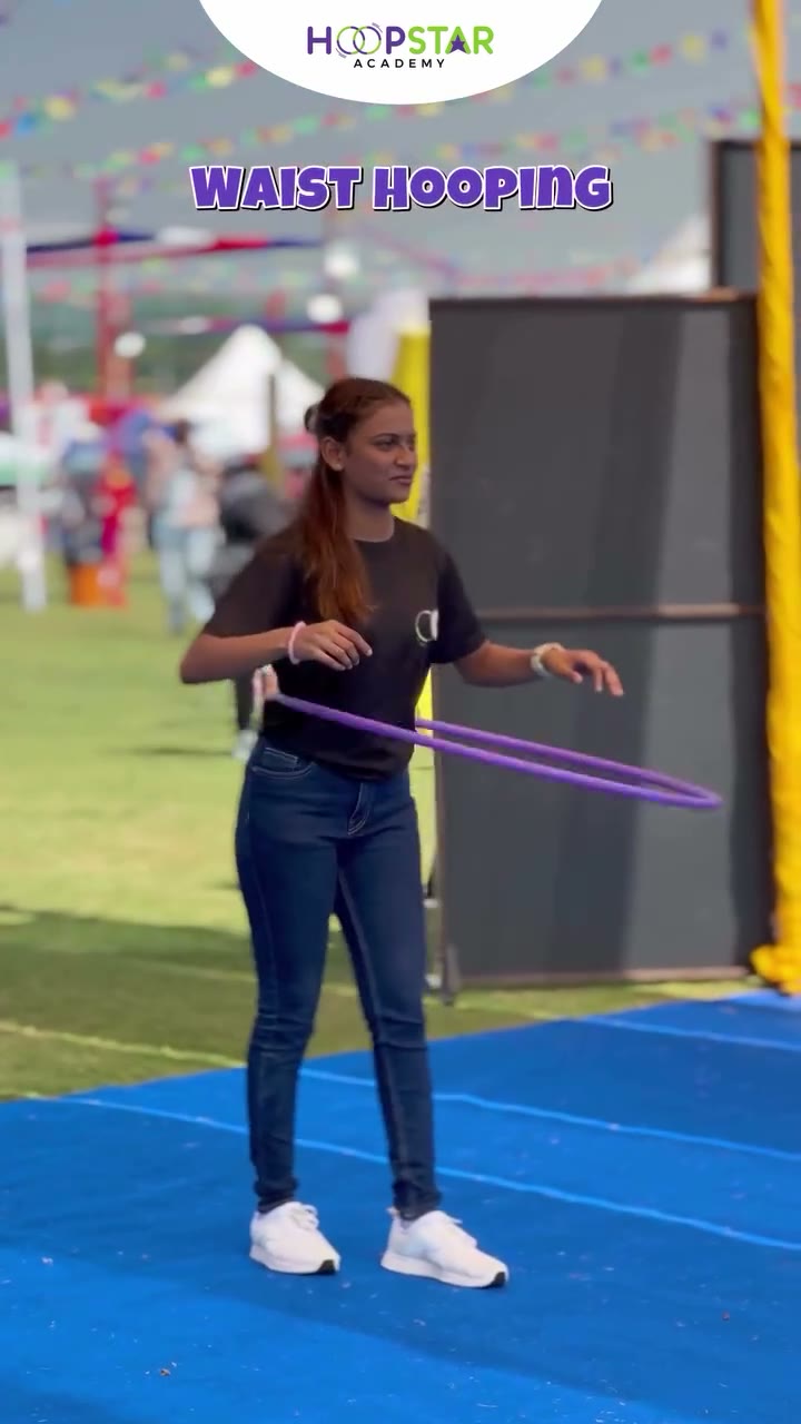 A child demonstrating Waist Hooping — a Level 1 hula hoop skill
