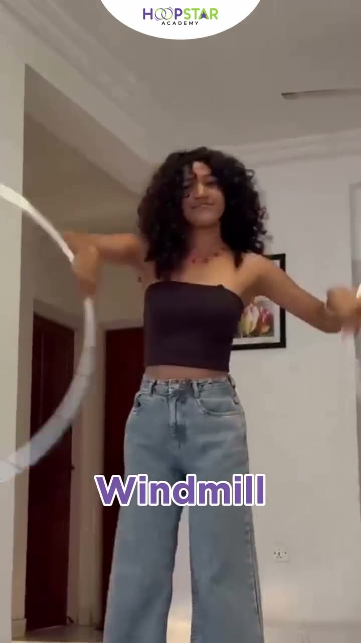 A child demonstrating Windmill — a Level 4 hula hoop skill