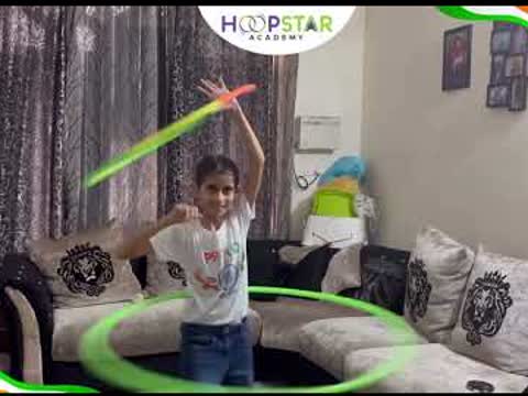 A HoopStar student performing an Independence Day hula hoop routine at home